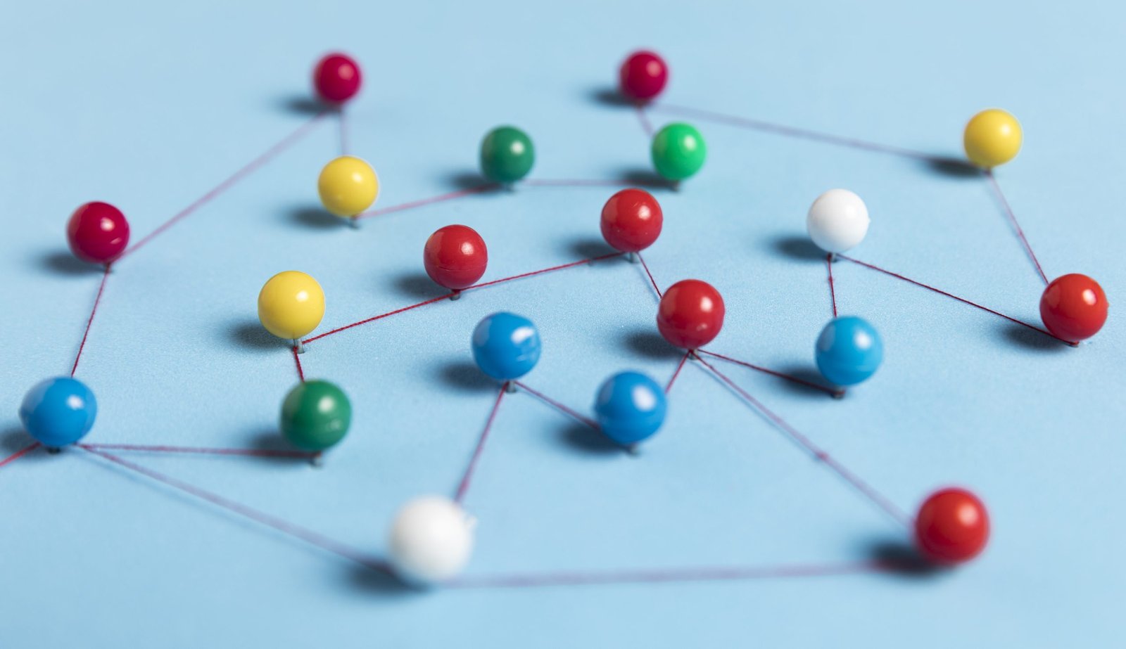 pushpins-with-thread-route-map-blue-background pushpins-with-thread-route-map-blue-background